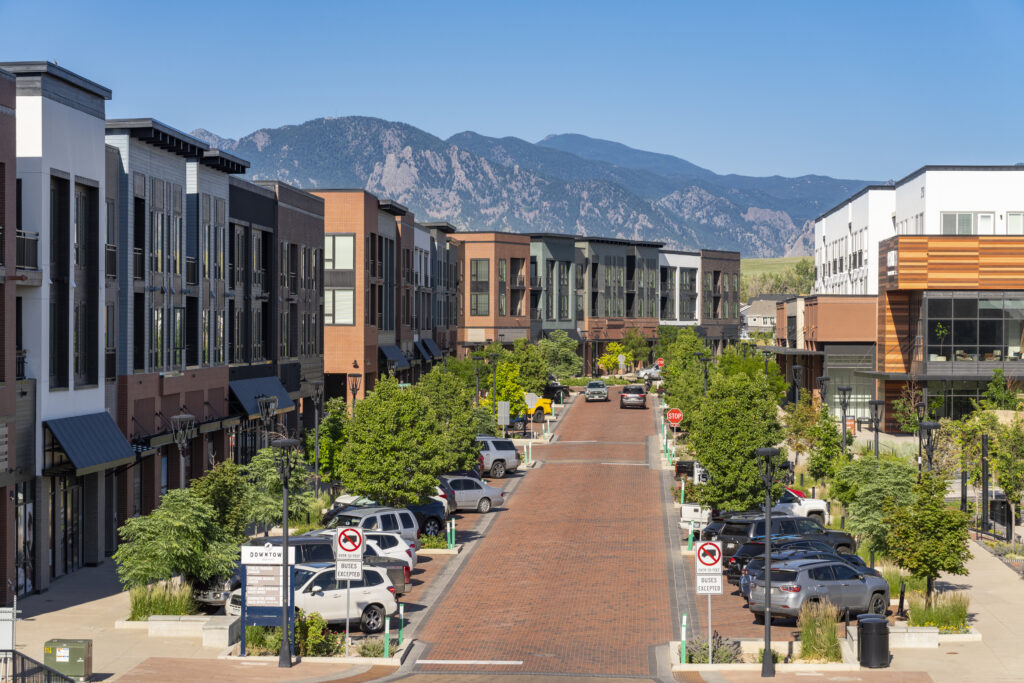 Downtown Superior's Main Street filled with cars and green trees.