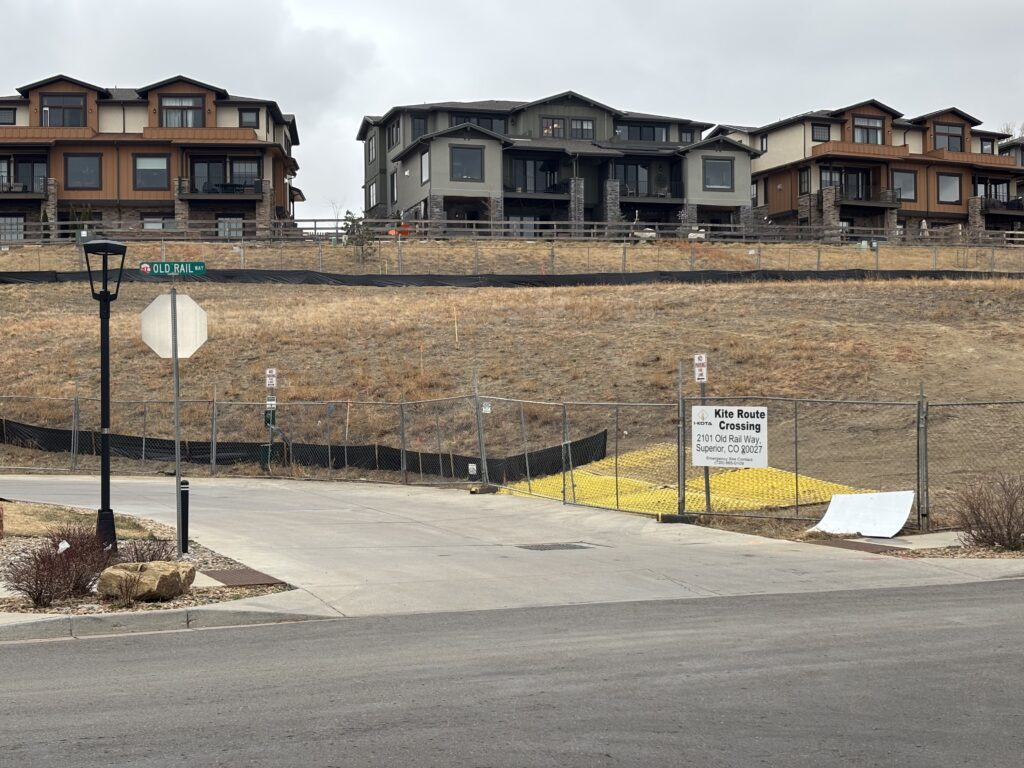 Land in foreground, homes in background